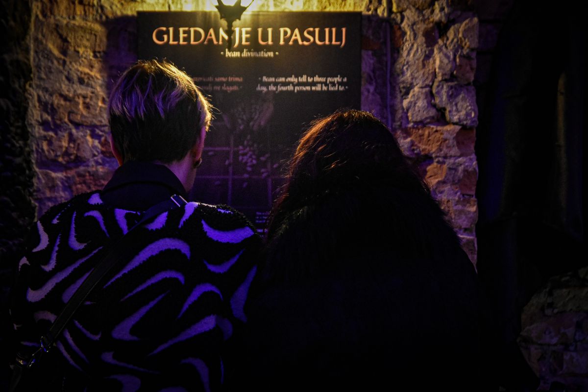 Bean Divination and Folk Fortune Telling Visitors reading an exhibit about bean divination at the Paranormal Museum